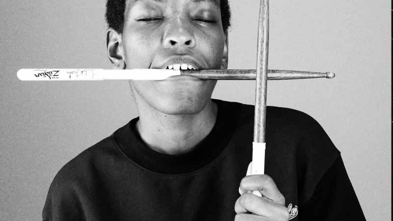 how-to-practice-drums Crossed Drum Sticks in Hand and Mouth