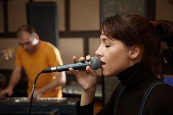 Woman Singing Into Micropohone